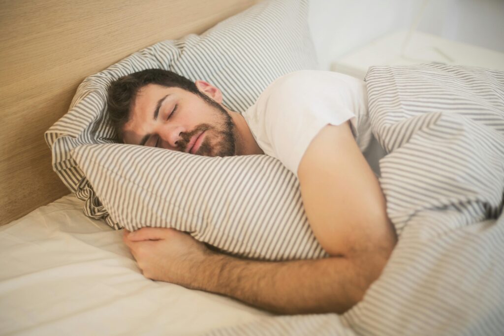 The Effects of Sleep Deprivation: Why Sleep Matters More Than You Think man sleeping in bed