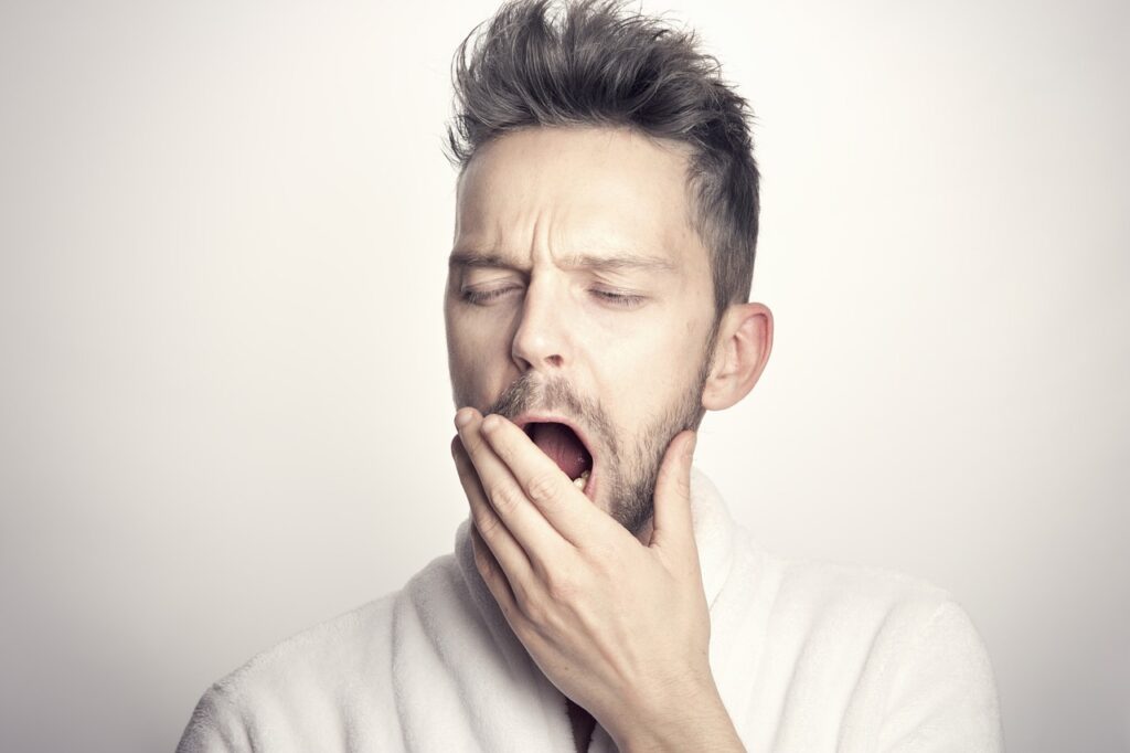 The Effects of Sleep Deprivation: Why Sleep Matters More Than You Think man yawning